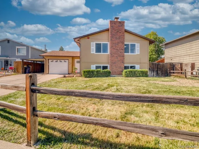 a view of house with backyard outdoor seating and barbeque oven