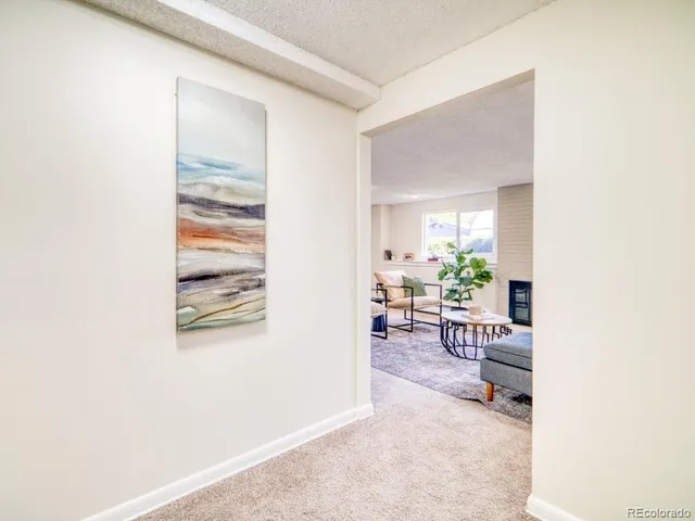 a view of a room with furniture and floor to ceiling window