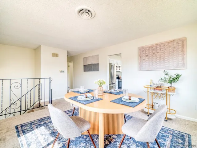 a dining room with furniture a rug and wooden floor