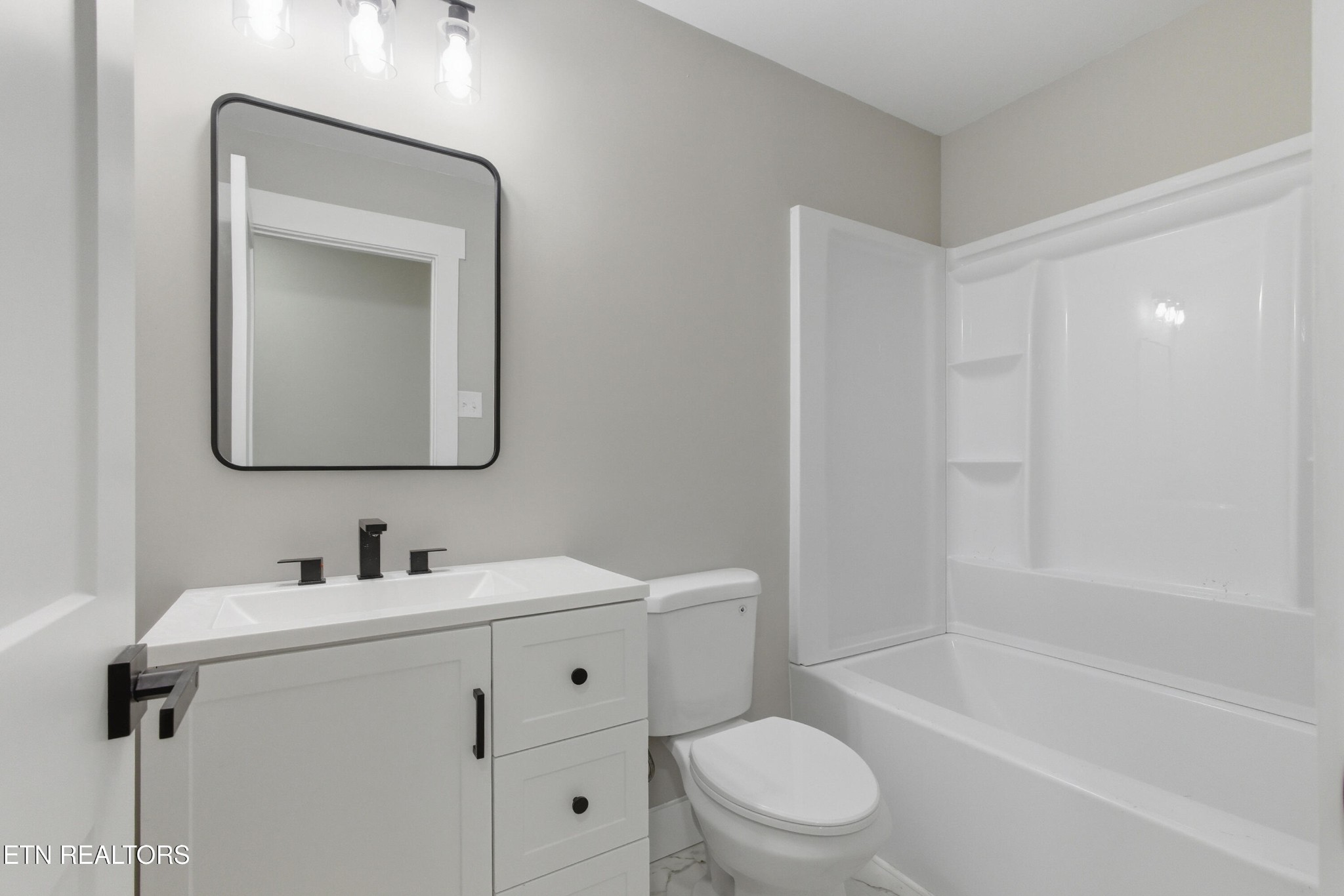 2241 Woods-Smith Road Knoxville, TN 37921 - Photo 16 of 37 a bathroom with a toilet sink vanity tub and mirror