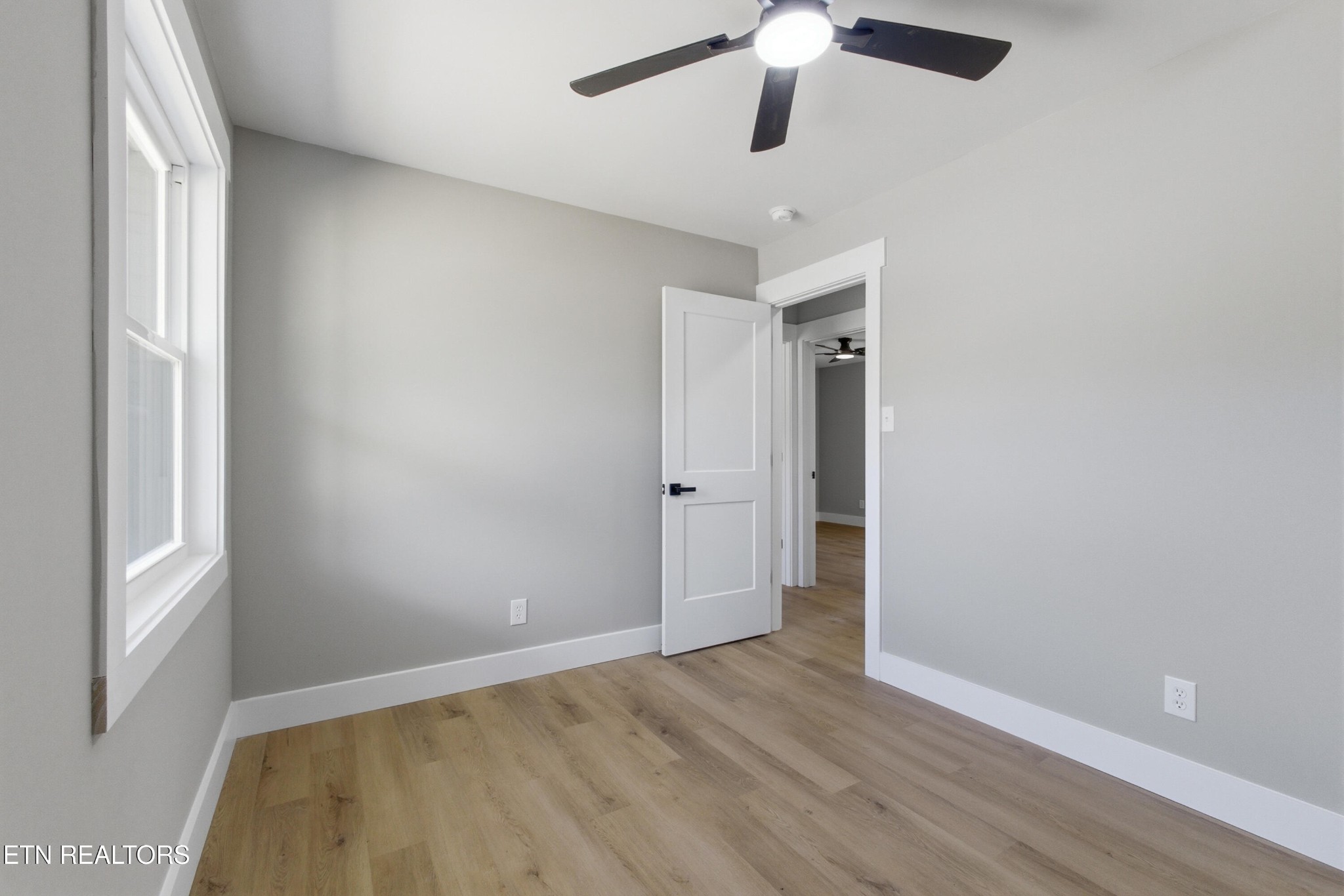 2241 Woods-Smith Road Knoxville, TN 37921 - Photo 18 of 37 wooden floor in an empty room with a window