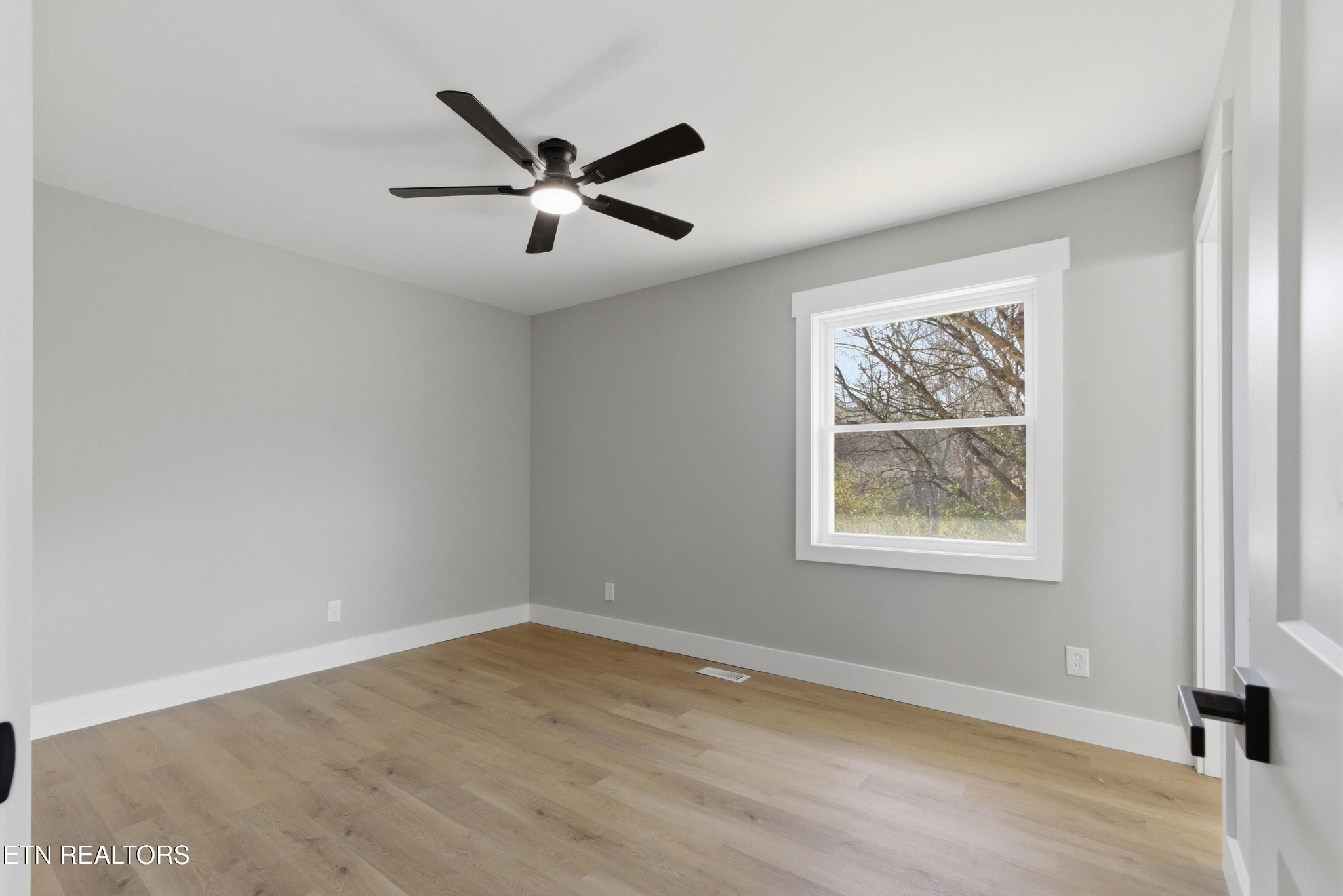 2241 Woods-Smith Road Knoxville, TN 37921 - Photo 19 of 37 a view of an empty room with wooden floor and a window