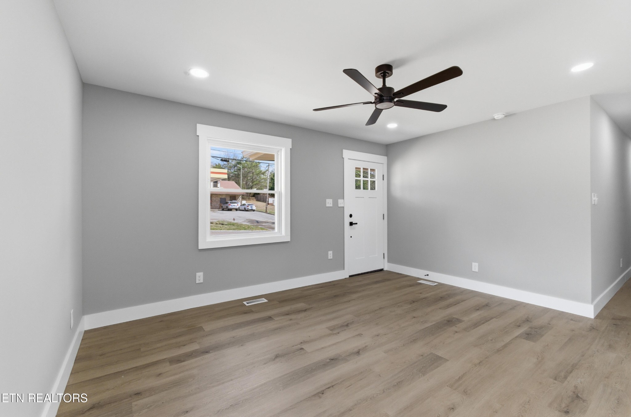 2241 Woods-Smith Road Knoxville, TN 37921 - Photo 8 of 37 a view of an empty room with window and wooden floor