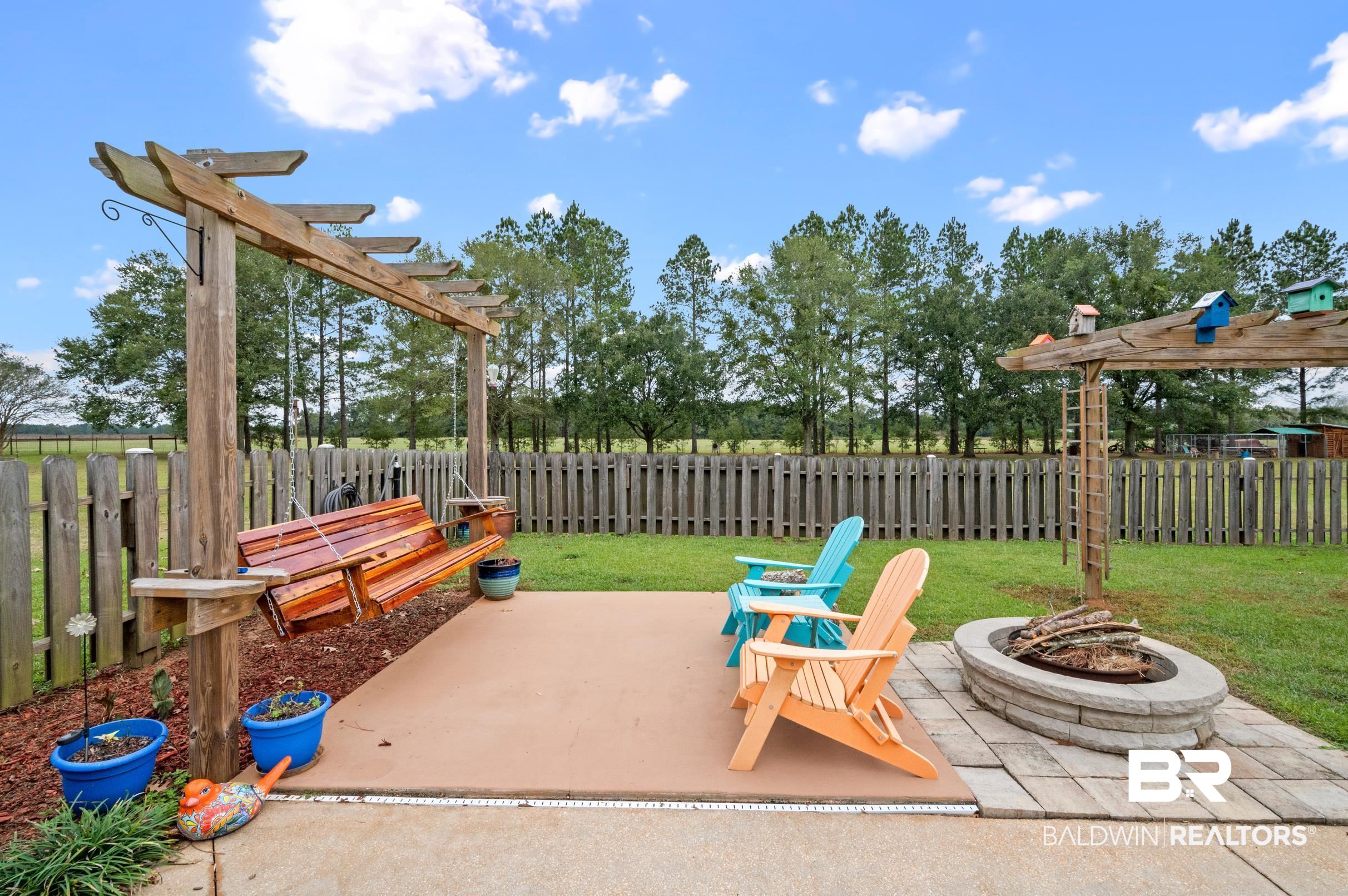 13871 Underwood Road Summerdale, AL 36580 - Photo 22 of 33 View of patio / terrace featuring a pergola and an outdoor fire pit