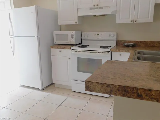 a kitchen with cabinets and a stove