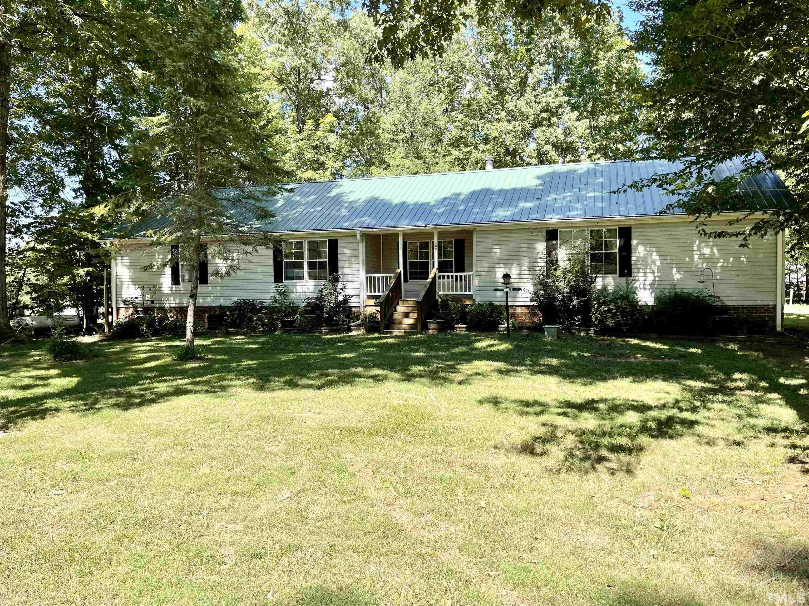 149 Waters Edge Road Henderson, NC 27537 - Photo 1 of 31 a front view of a house with a yard