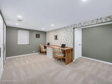 a bedroom with a bed and a chair
