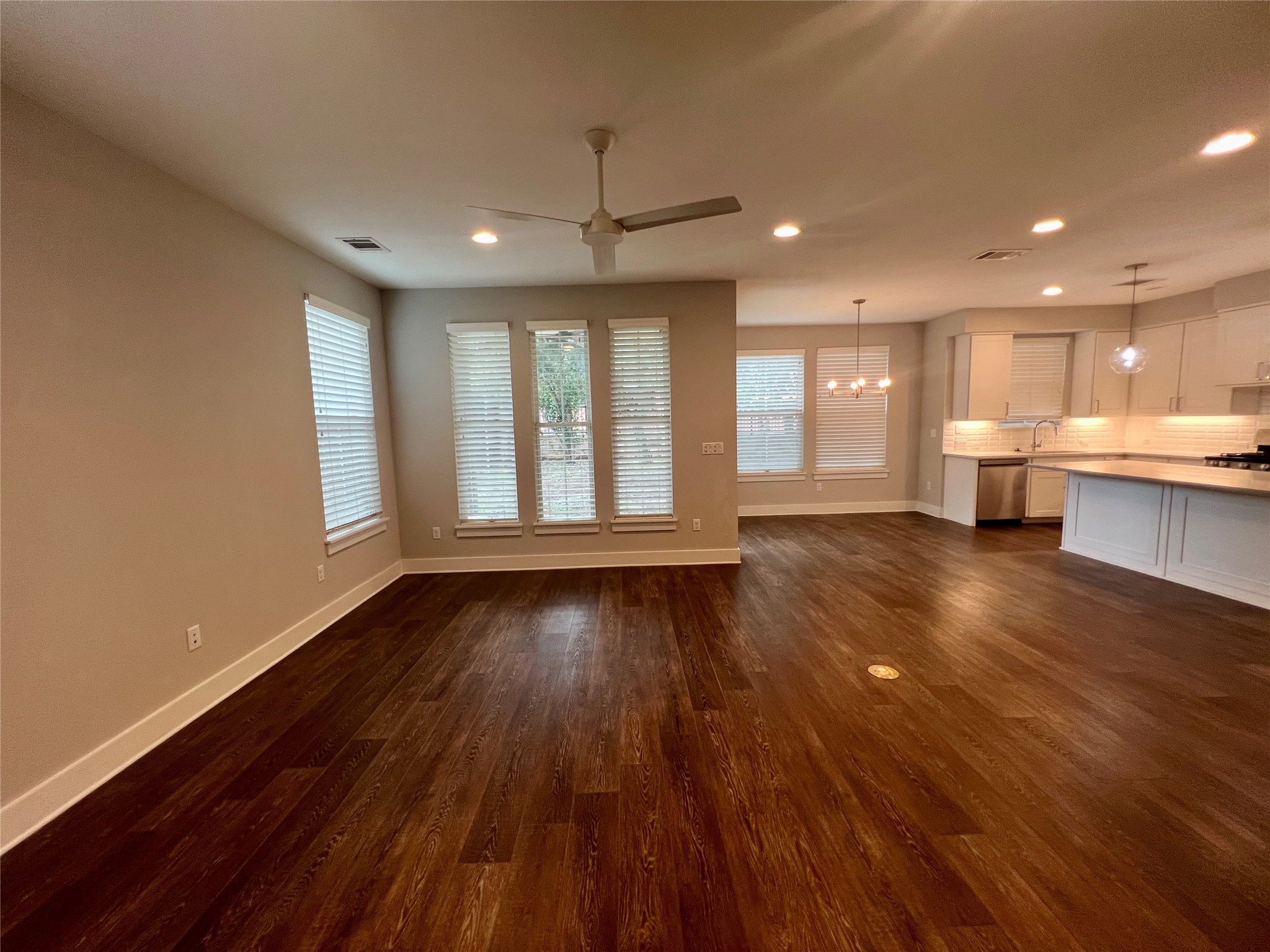 6515 Davis Lane, Unit 10 Austin, TX 78749 - Photo 2 of 22 An open-concept living area with lustrous wood flooring flows seamlessly into a modern kitchen.