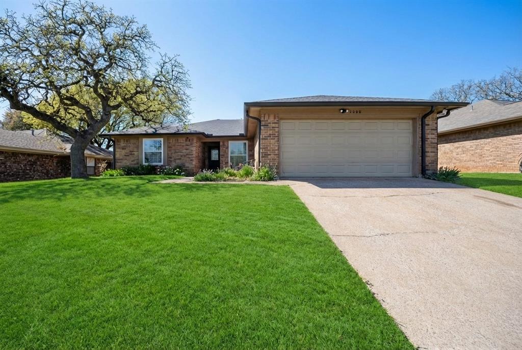 5008 Hawkins Cemetery Road Arlington, TX 76017 - Photo 1 of 35 Single story home with brick siding, a front lawn, driveway, and an attached garage