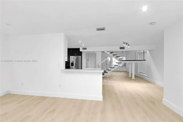 a view of a living room and kitchen with furniture