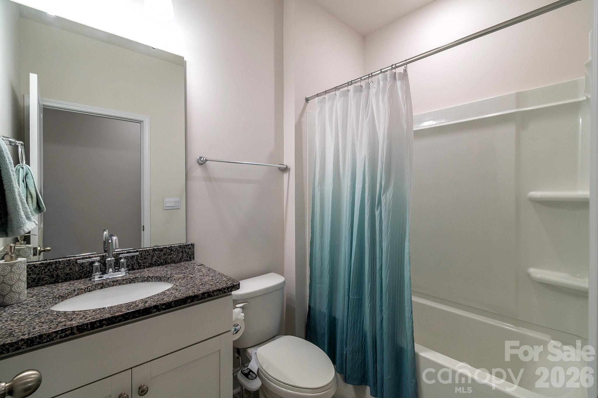 1630 Fitzgerald Street Northwest Concord, NC 28027 - Photo 14 of 38 a bathroom with a granite countertop sink toilet and shower