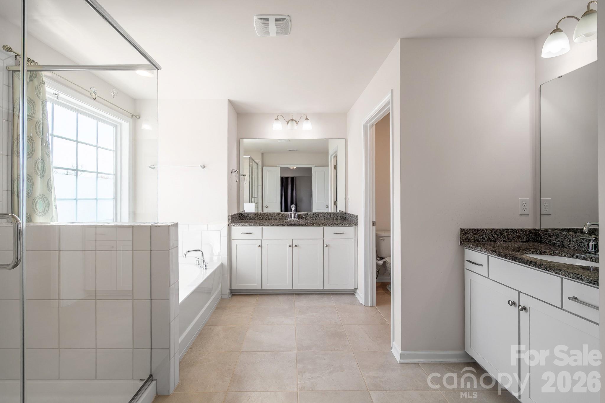 1630 Fitzgerald Street Northwest Concord, NC 28027 - Photo 20 of 38 a bathroom with a granite countertop sink two mirror and window
