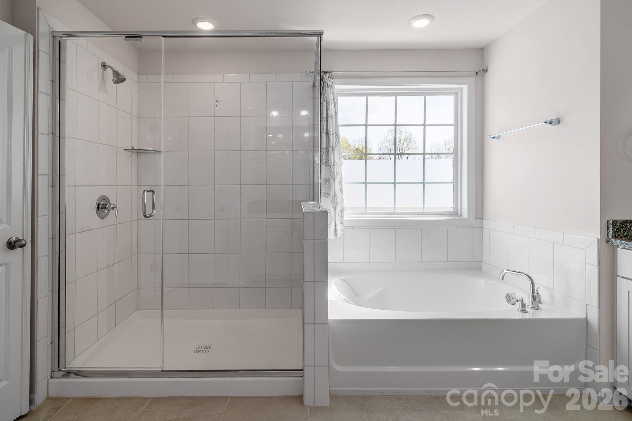 1630 Fitzgerald Street Northwest Concord, NC 28027 - Photo 21 of 38 a bathroom with a bathtub and shower