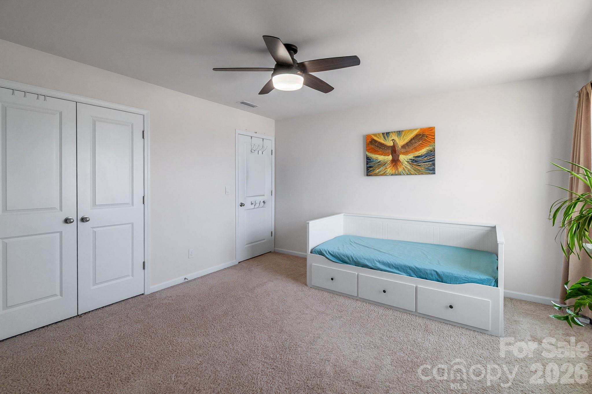 1630 Fitzgerald Street Northwest Concord, NC 28027 - Photo 29 of 38 a living room with furniture and a ceiling fan