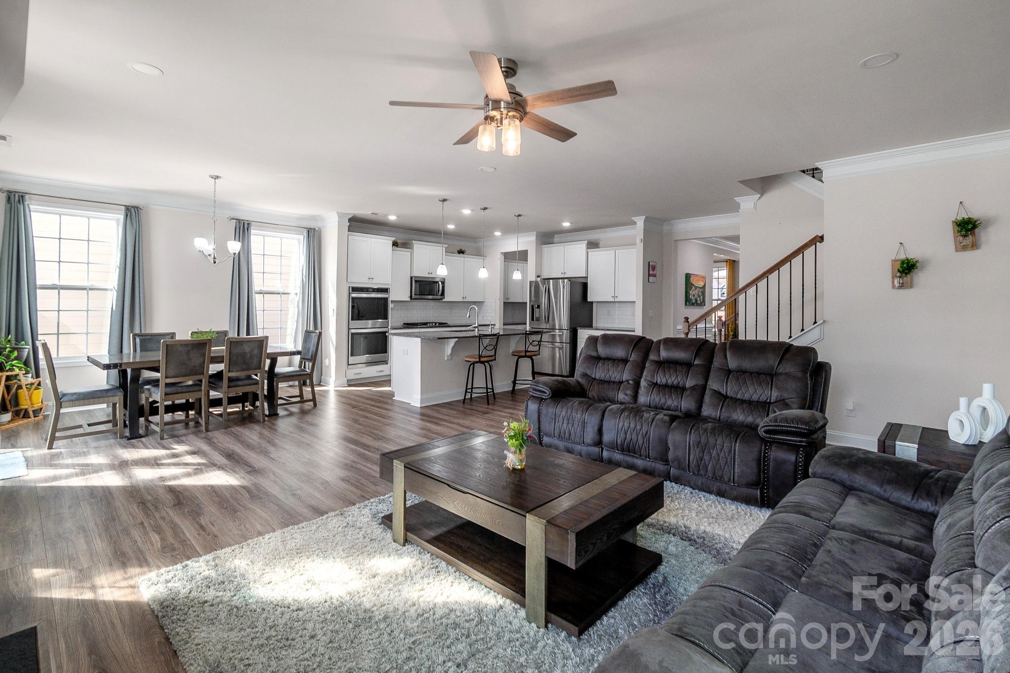 1630 Fitzgerald Street Northwest Concord, NC 28027 - Photo 3 of 38 a living room with lots of furniture kitchen view and a table