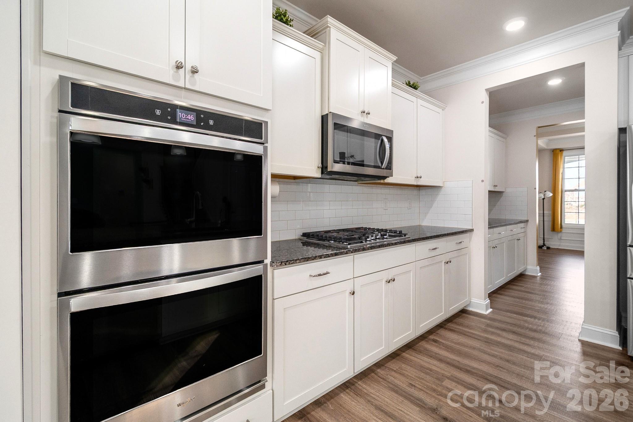 1630 Fitzgerald Street Northwest Concord, NC 28027 - Photo 8 of 38 a kitchen with stainless steel appliances white cabinets and stove