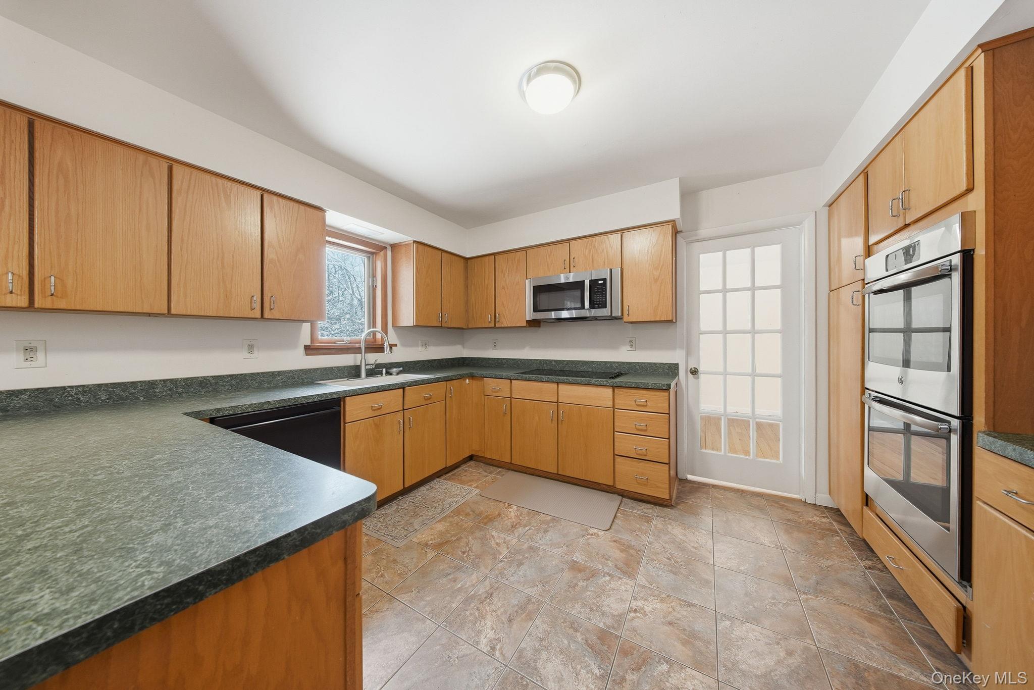 139 Renner Road Mountain Dale, NY 12763 - Photo 11 of 49 a kitchen with stainless steel appliances granite countertop a stove a sink and a refrigerator