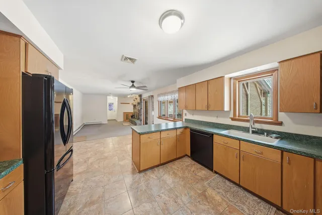 a large kitchen with cabinets and stainless steel appliances