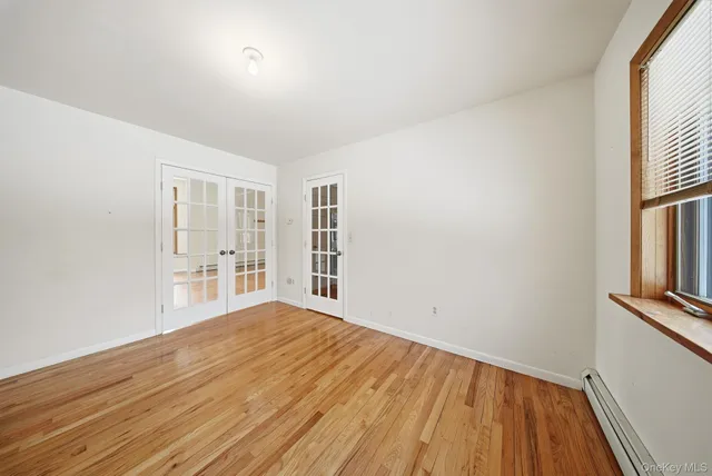 a view of empty room with floor to ceiling window