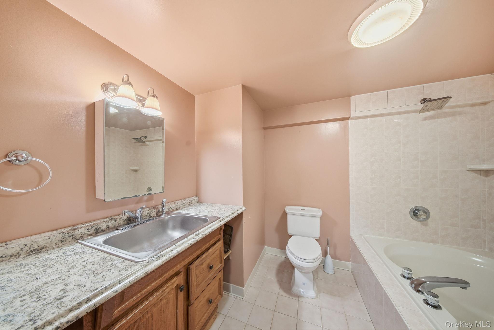 139 Renner Road Mountain Dale, NY 12763 - Photo 32 of 50 Bathroom featuring vanity, light tile patterned flooring, and tiled shower / bath combo