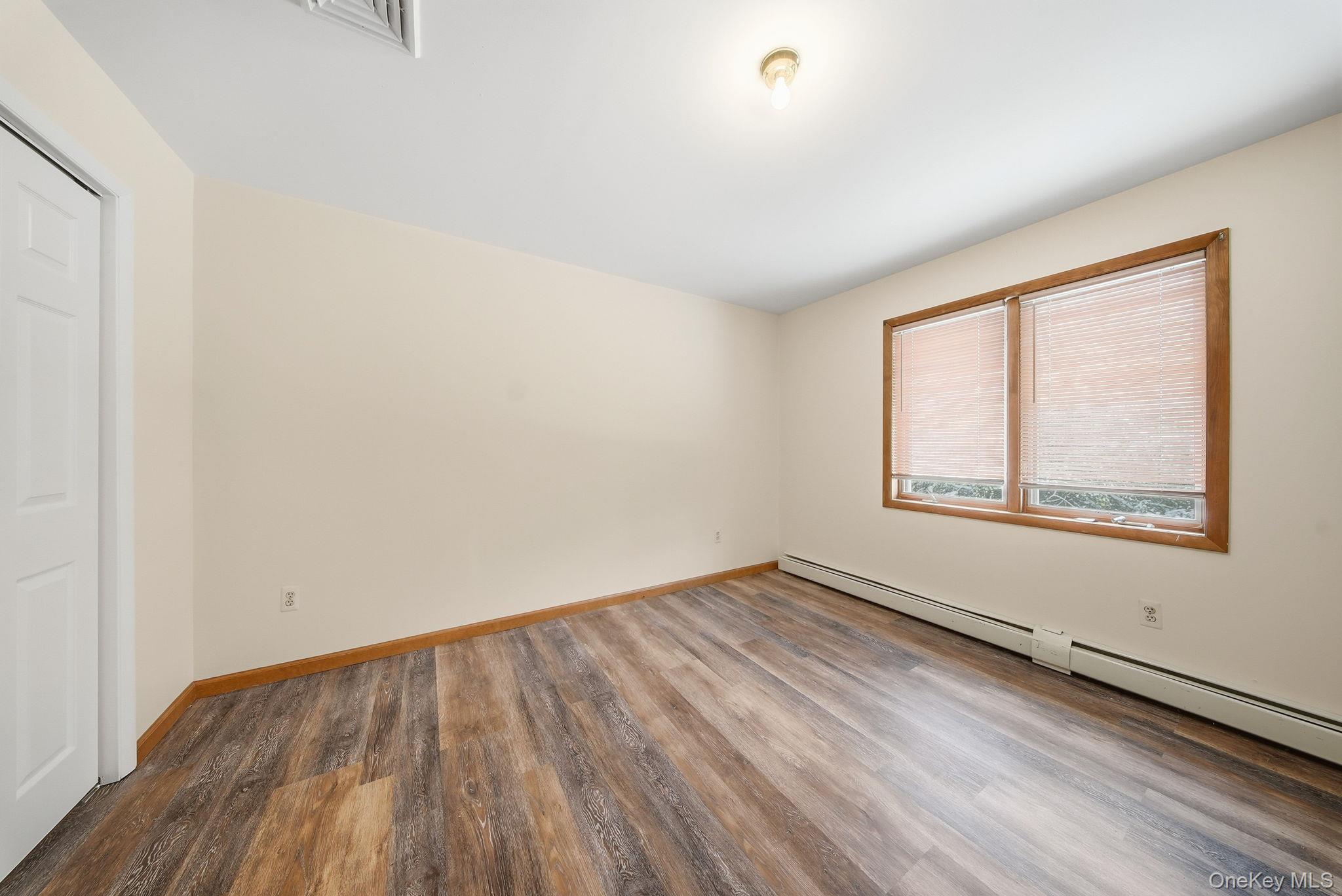 139 Renner Road Mountain Dale, NY 12763 - Photo 35 of 49 an empty room with wooden floor and windows