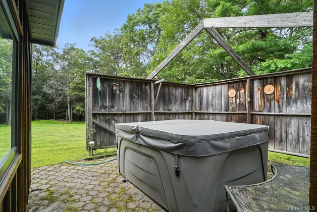 a view of a patio with a table chairs and backyard