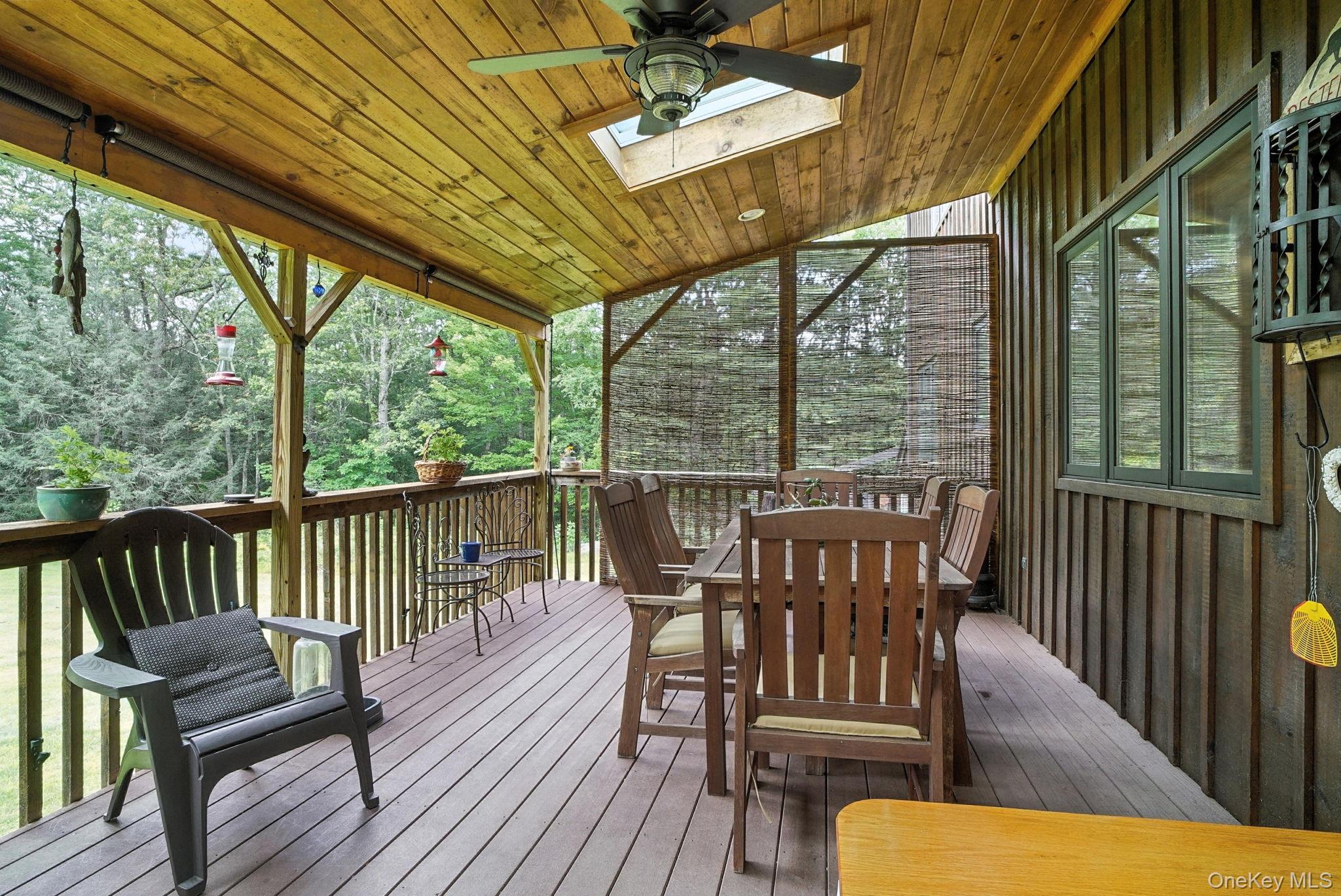 139 Renner Road Mountain Dale, NY 12763 - Photo 42 of 50 Wooden terrace featuring outdoor dining area, sky lights and ceiling fan