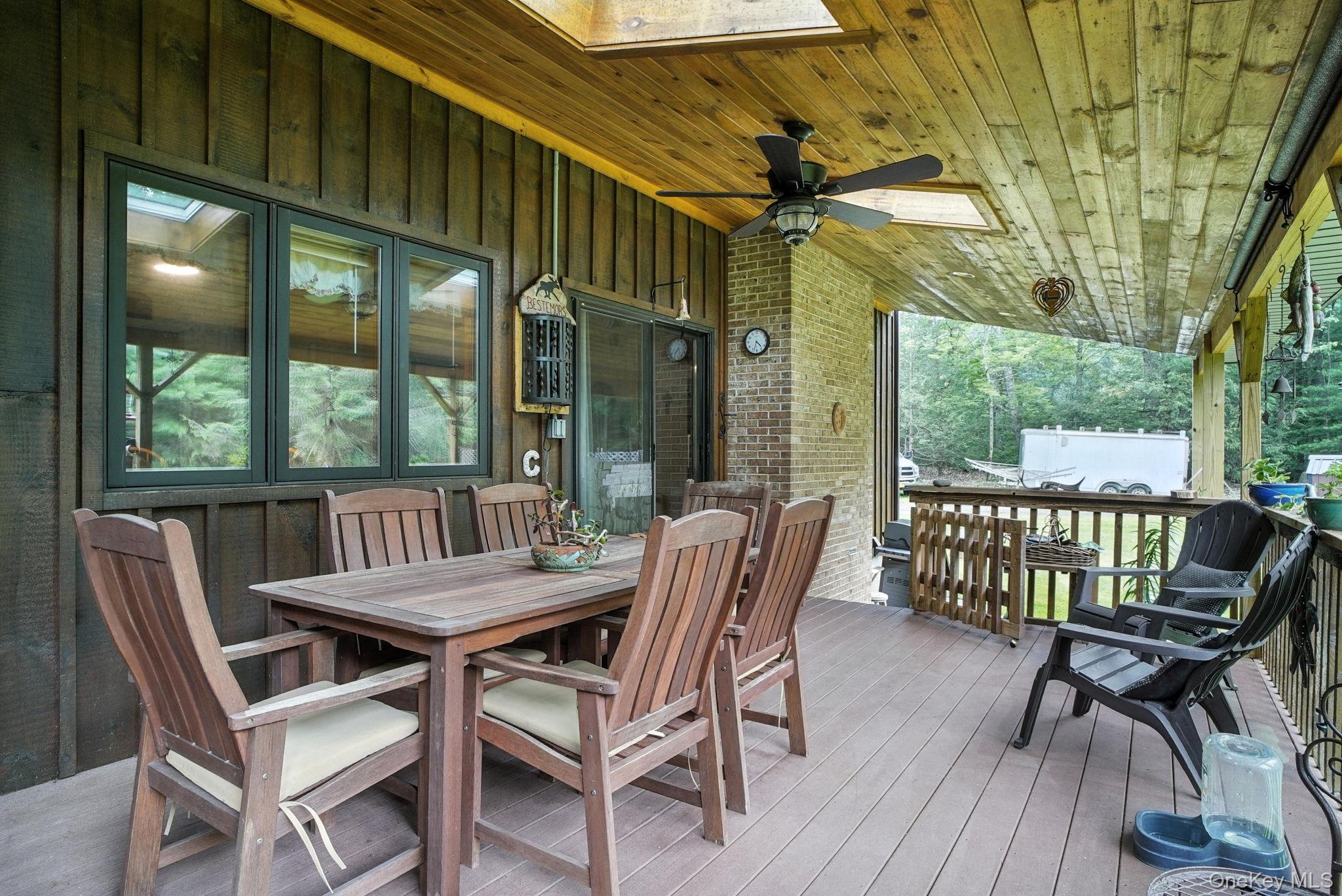 139 Renner Road Mountain Dale, NY 12763 - Photo 44 of 49 Large Wooden deck featuring a ceiling fan and outdoor dining area