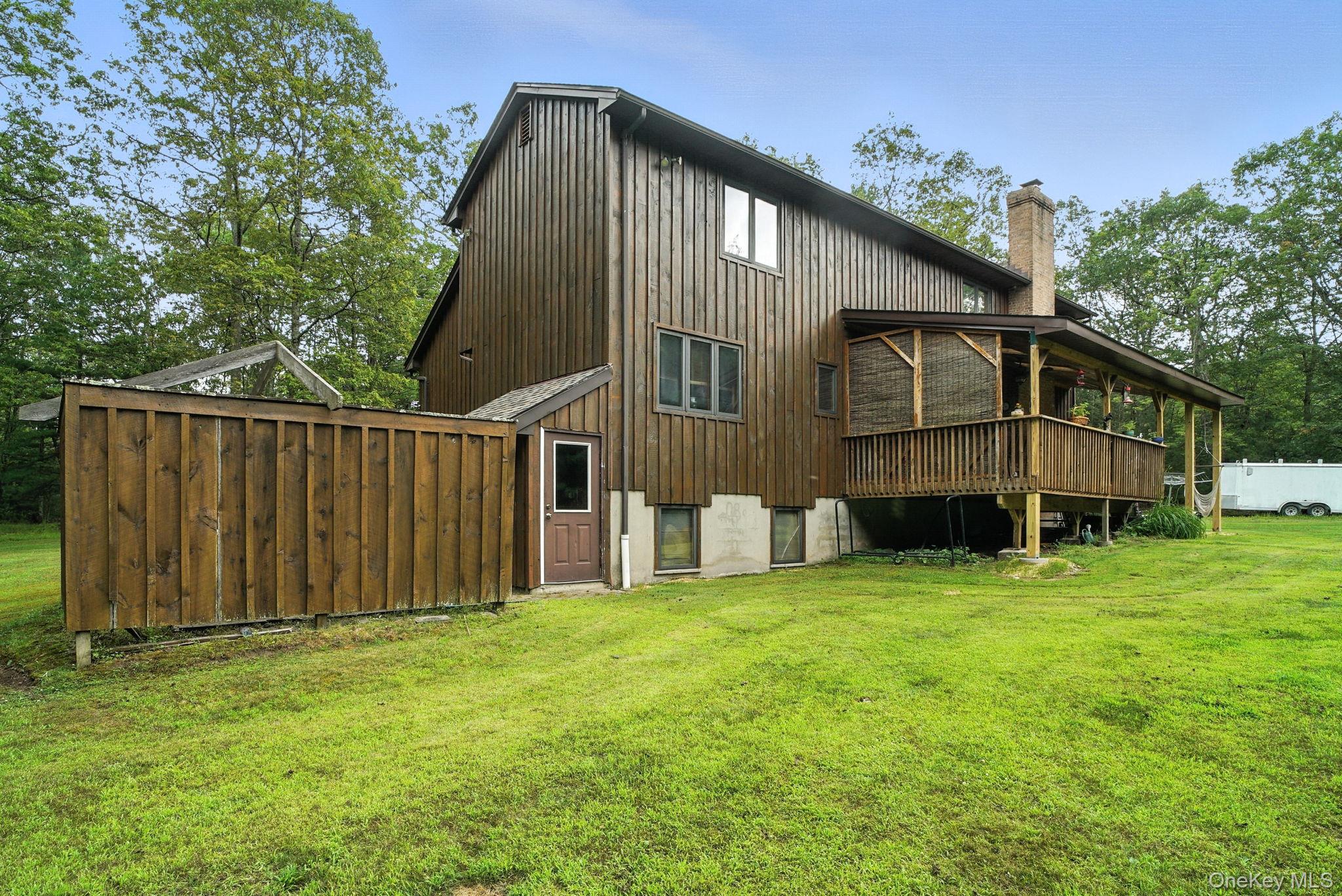 139 Renner Road Mountain Dale, NY 12763 - Photo 44 of 50 Rear view of property featuring a chimney and a lawn