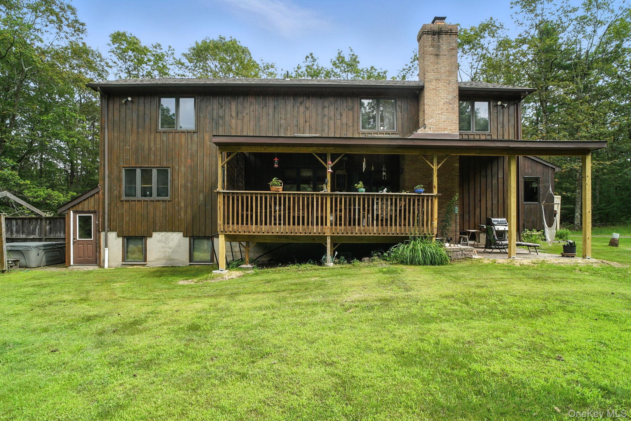 139 Renner Road Mountain Dale, NY 12763 - Photo 47 of 49 Back of house featuring a lawn and a chimney