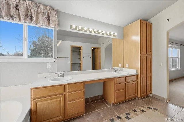a bathroom with a granite countertop sink mirror and shower