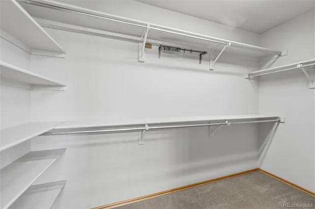a bathroom with a bathtub shower sink vanity mirror and toilet