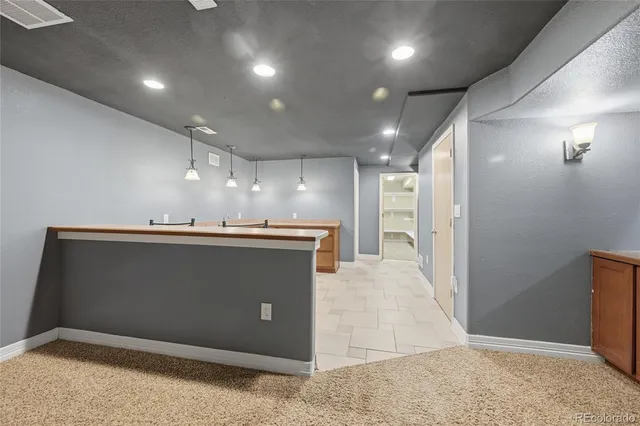 a spacious bathroom with a sink and mirror