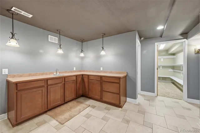 a bathroom with a granite countertop sink toilet and a mirror