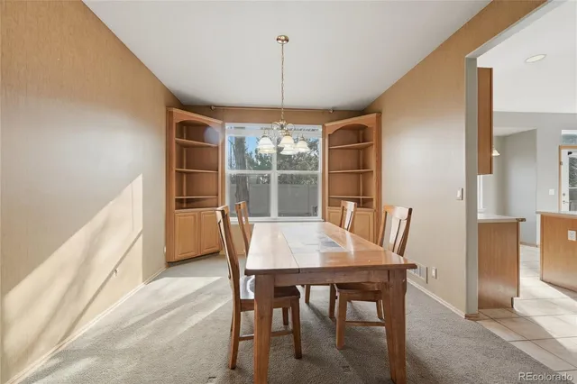 a view of a dining room with furniture and chandelier