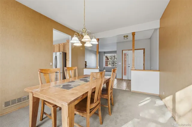 a view of a dining room with furniture and chandelier