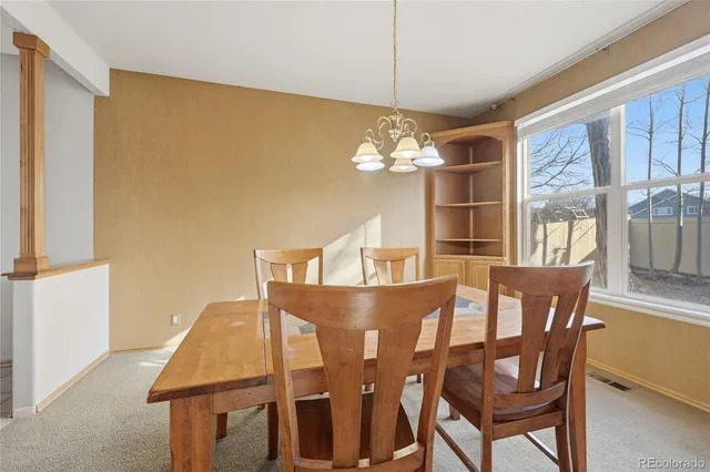 a kitchen with stainless steel appliances granite countertop a refrigerator a stove and a sink