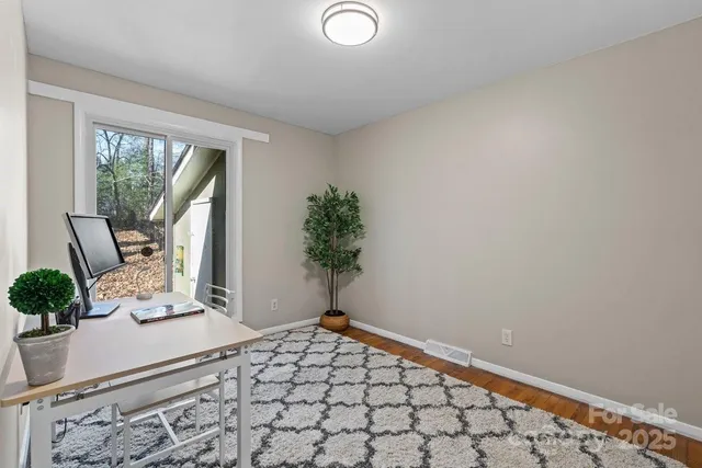a room with a large bed and a potted plant