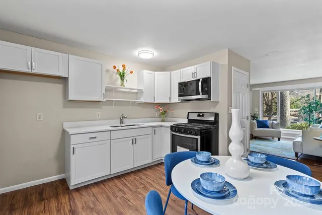 a kitchen with a sink stove and microwave
