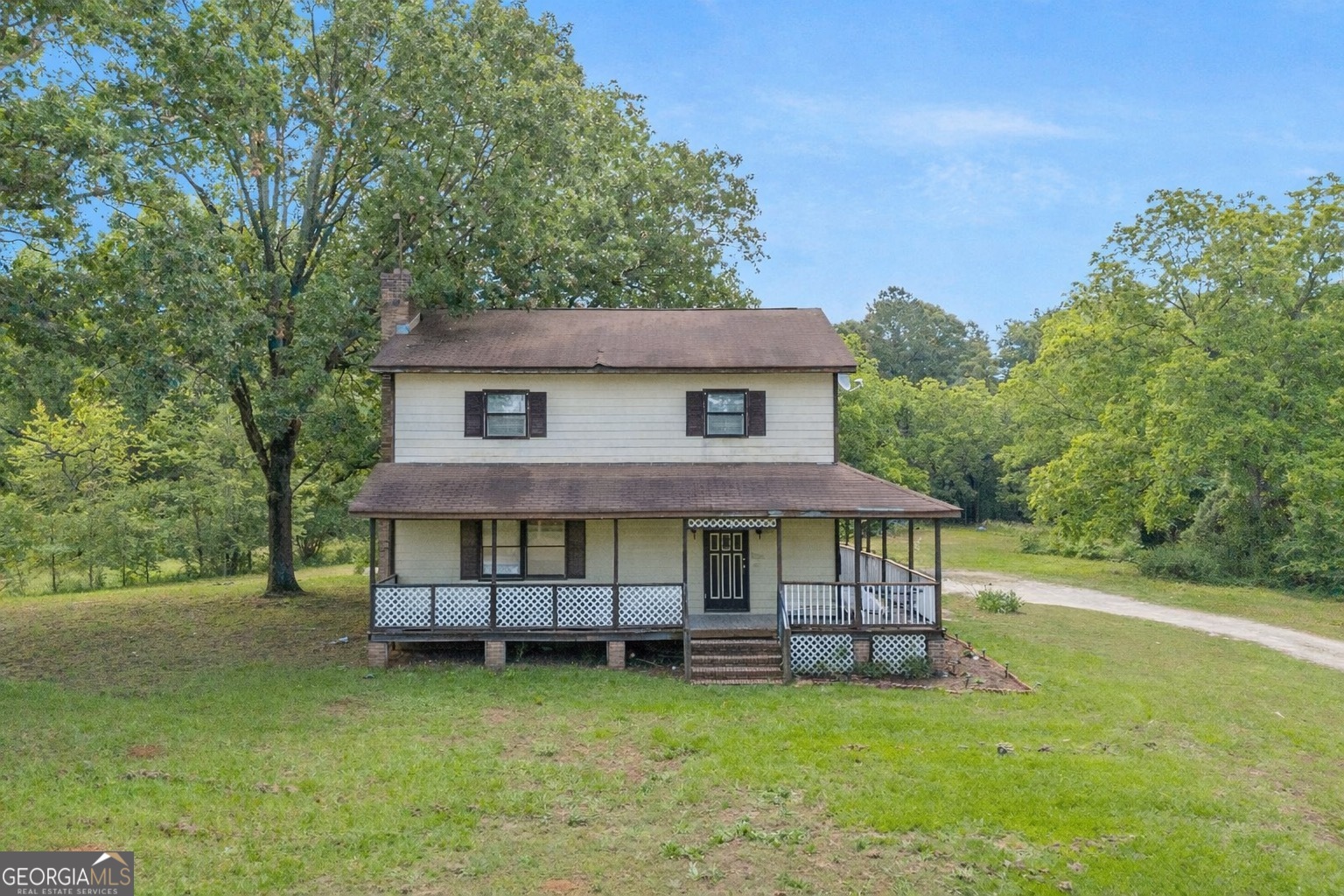 a view of a house with a yard and sitting area