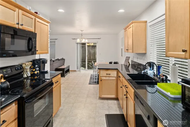 a kitchen with a stove a sink and a microwave