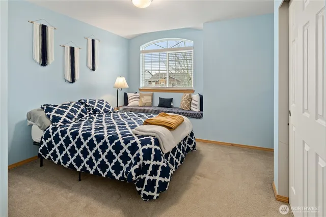 a bedroom with a bed and window