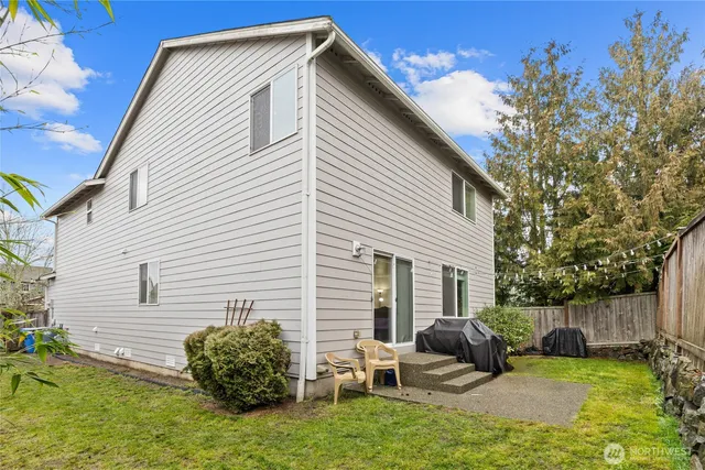 a backyard of a house with table and chairs