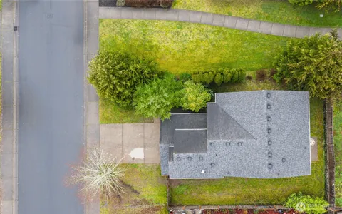 an aerial view of a house with a yard basket ball court and outdoor seating