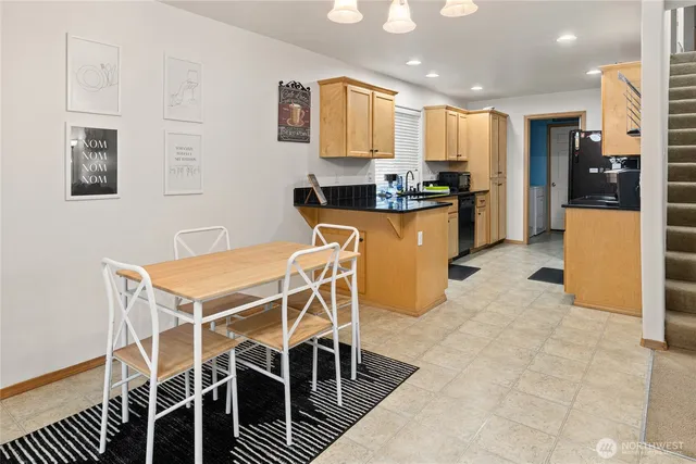 a kitchen with stainless steel appliances kitchen island granite countertop a refrigerator and microwave