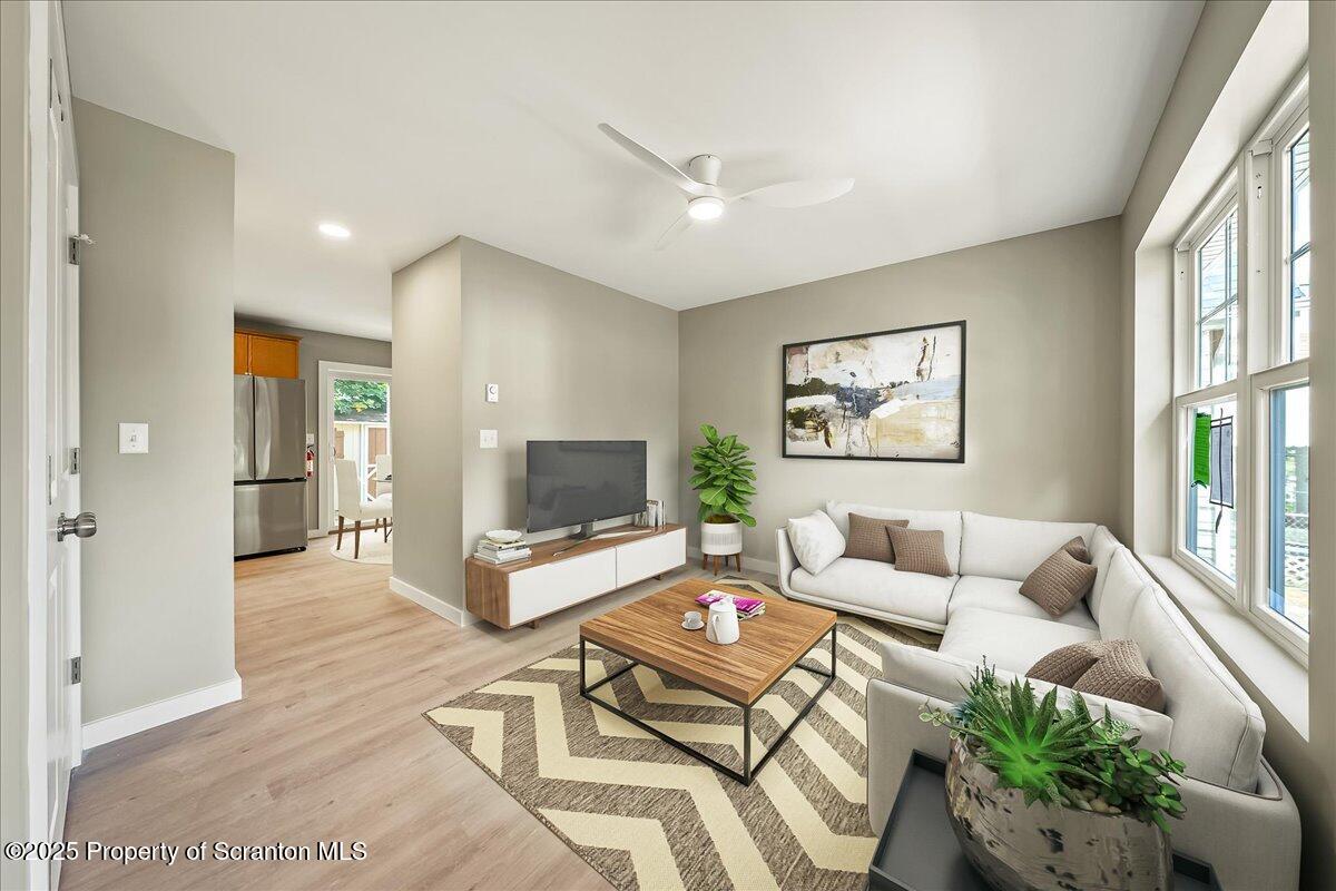 820 822 Delaware Street Scranton, PA 18509 - Photo 18 of 48 a living room with furniture a flat screen tv and a floor to ceiling window