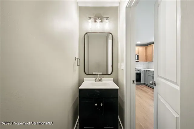 a kitchen with a sink cabinets stainless steel appliances and a window