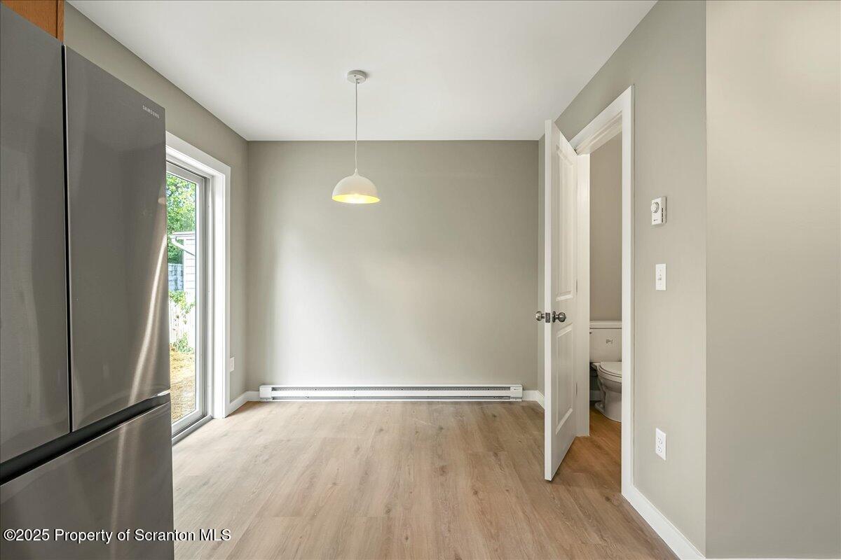 820 822 Delaware Street Scranton, PA 18509 - Photo 7 of 48 a view of an empty room with wooden floor and a window