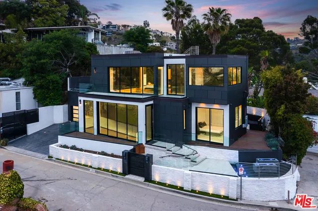 a front view of a house with a garden