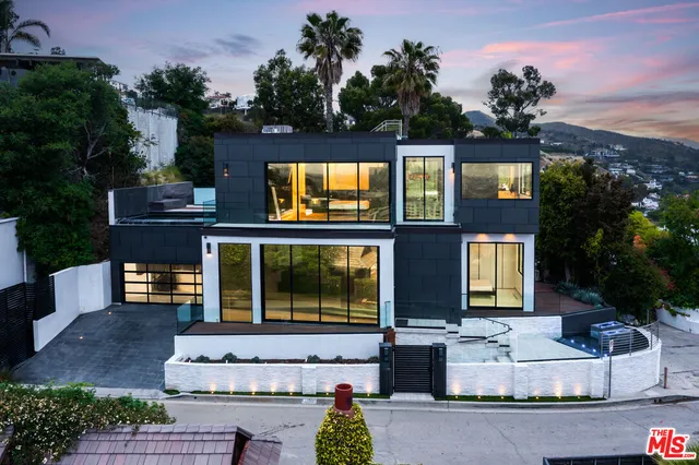 a front view of house with a garden